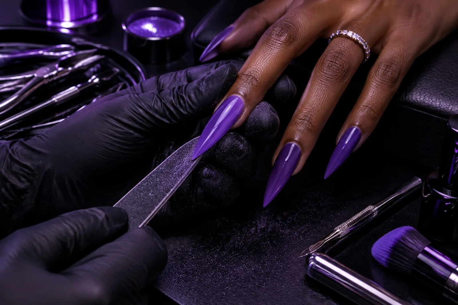 Illustrative artist filing a long stiletto nail into shape